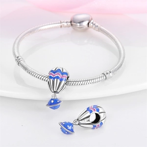 Detail of silver snake chain bracelet with blue and pink enamel hot air balloon charms
