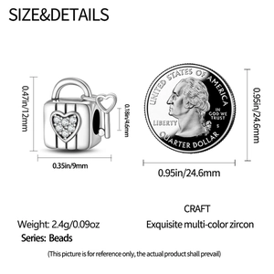 Size chart showing heart lock and key charm measurements with a coin for scale