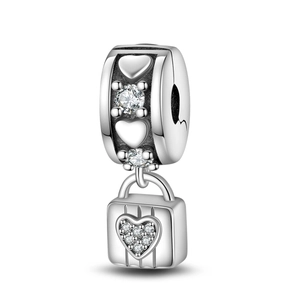Macro shot of silver heart lock charm with sparkling zircons for DIY charm bracelets