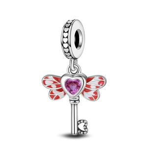 Silver wing key charm featuring pink heart crystal and red enamel on white background