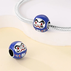 Dettaglio del charm Daruma in smalto blu con carattere Fu fortunato su catena a serpente