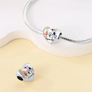 Detail of silver heart charm with colorful family graffiti and Family engraving on bracelet