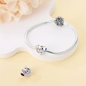 Detail of silver heart charm with family painting on snake chain bracelet