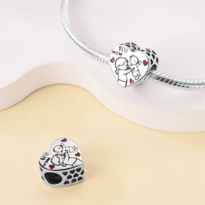 Silver-plated heart charm with Best Mom engraving on a snake chain bracelet