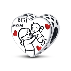Macro detail of heart-shaped silver charm with Best Mom engraving and red enamel heart