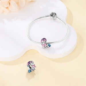 Detail of silver snake chain bracelet with colorful unicorn charm and enamel finish