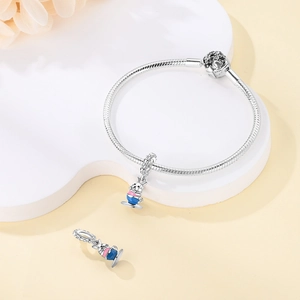 Detailed view of silver snake chain bracelet with rabbit teacup enamel charms and zircons