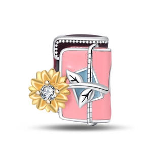 Detail of pink envelope charm with golden sunflower and zircon inlay for DIY bracelet