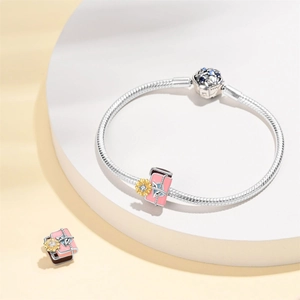 Silver snake chain bracelet featuring a pink enamel sunflower charm with zircon
