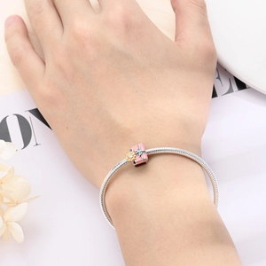 Silver snake chain bracelet with pink enamel gift box pendant and sunflower detail