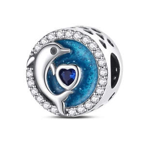 Vista macro de amuleto de delfín de plata con corazón de esmalte azul y circón brillante