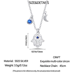Macro detail of S925 silver necklace with Hamsa hand and crescent moon charms