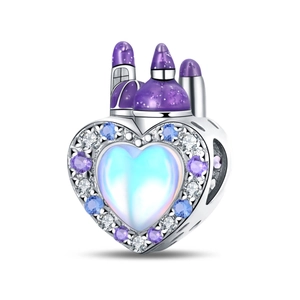Macro detail of fairy tale castle charm with heart shape and purple enamel towers