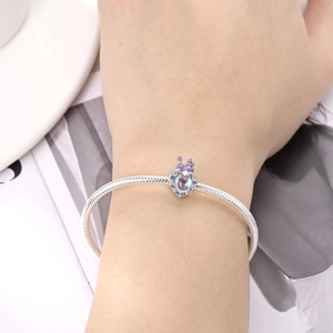Detailed view of S925 silver snake chain bracelet with blue heart charm on wrist