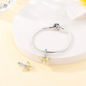 Detailed close-up of a silver snake chain bracelet featuring a hollow butterfly charm