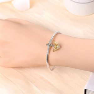 Luminous firefly bee pendant on silver snake chain bracelet with golden filigree wings