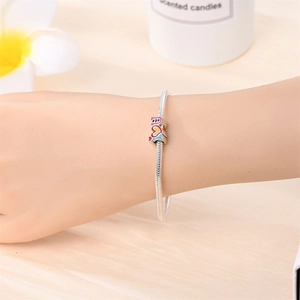 Close-up of silver snake chain bracelet featuring colorful LOVE enamel charms and beads