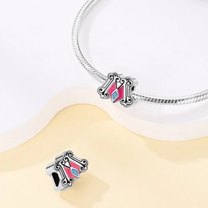 Detail of dream castle unicorn charm with pink blue enamel on silver snake chain