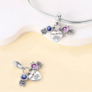 Macro detail of S925 silver charms with Yes I Do engraving and colorful cubic zirconia