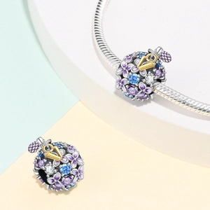 Silver-plated perfume bottle charm with purple enamel flowers and colored zircons on a chain