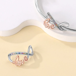 Detail of silver Mobius charm with rainbow cubic zirconia and rose gold Love script