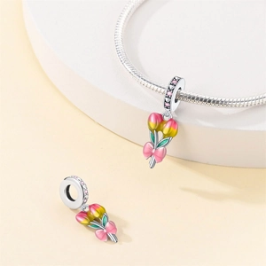 Detail of tulip flower charm with pink yellow enamel and zircon inlay for bracelet