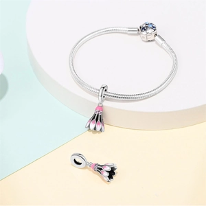 Detail of silver snake chain bracelet with pink enamel badminton shuttlecock charm