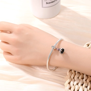 Silver bracelet with an enamel badminton shuttlecock charm on a snake chain