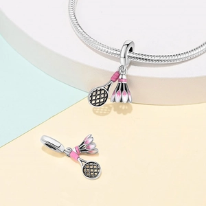 Detailed close-up of a silver badminton racket and shuttlecock charm with pink enamel