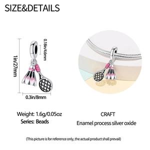 Macro shot of silver badminton racket and shuttlecock charm with pink enamel details