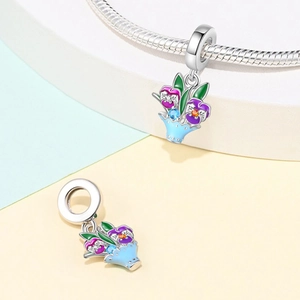 Floral basket charm detail with purple pansies and enamel leaves on silver bracelet