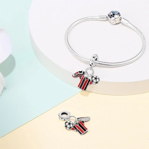 Detailed shot of football soccer jersey and shoe charms on a silver snake chain bracelet