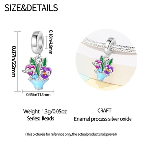 Detail view of silver enamel flower basket charm with dimensions 22mm by 11.5mm