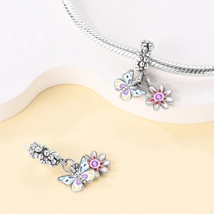 Silver butterfly and daisy charm with purple zircon on a snake chain bracelet