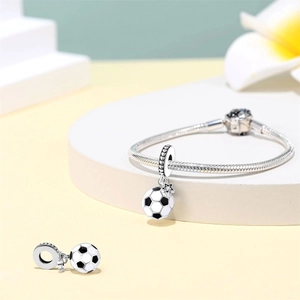 Detail of silver snake chain bracelet with black and white enamel soccer charms