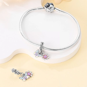 Silver snake chain bracelet with purple enamel butterfly and daisy flower charms