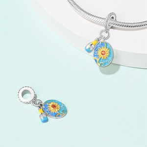 Detailed shot of sunflower palette and paintbrush charms for DIY jewelry making