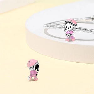 Detail view of soccer girl charm bead in pink enamel for DIY bracelet jewelry