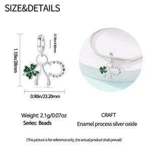Detail of silver clover horseshoe charm with dimensions 28x23.2mm and green enamel finish