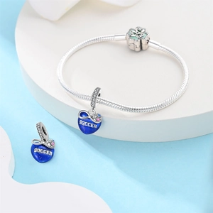 Detailed close-up of blue enamel soccer heart charms on silver snake chain bracelet