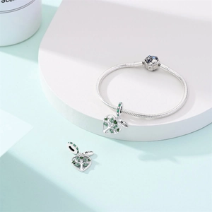 Macro detail of Tree of Life charm with green zircons and Mom tag on silver snake chain