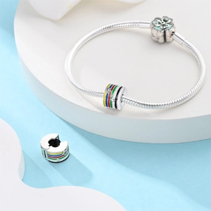 Detalle de pulsera de plata con abalorio de estrella esmaltada y cierre con forma floral