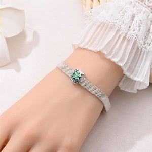 Milanese mesh silver bracelet with green enamel clover and zircon details on wrist