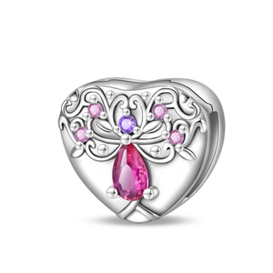 Macro shot of silver heart charm with pink pear-shaped stone and purple crystal accents