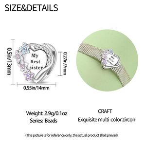 Macro shot of silver heart bead with colorful zircon and My Best Sister engraving