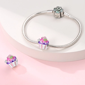 Détail du charme macaron avec émail floral rose sur un bracelet en chaîne serpent argent