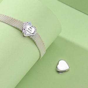 Detailed shot of silver mesh bracelet featuring a My Best Sister engraved heart clasp