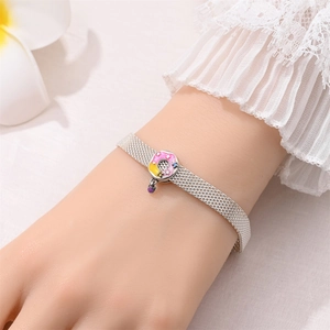 Detail of silver mesh bracelet featuring a pink enamel pendant with sparkling accents