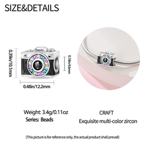 Macro detail of camera bead charm with colorful zircon stones and 'Smile' engraving