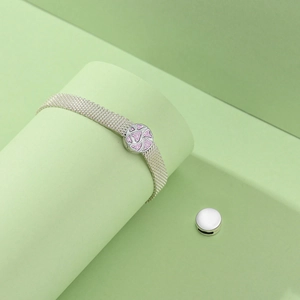 Detailed view of silver mesh bracelet with pink heart charm and interchangeable clasp